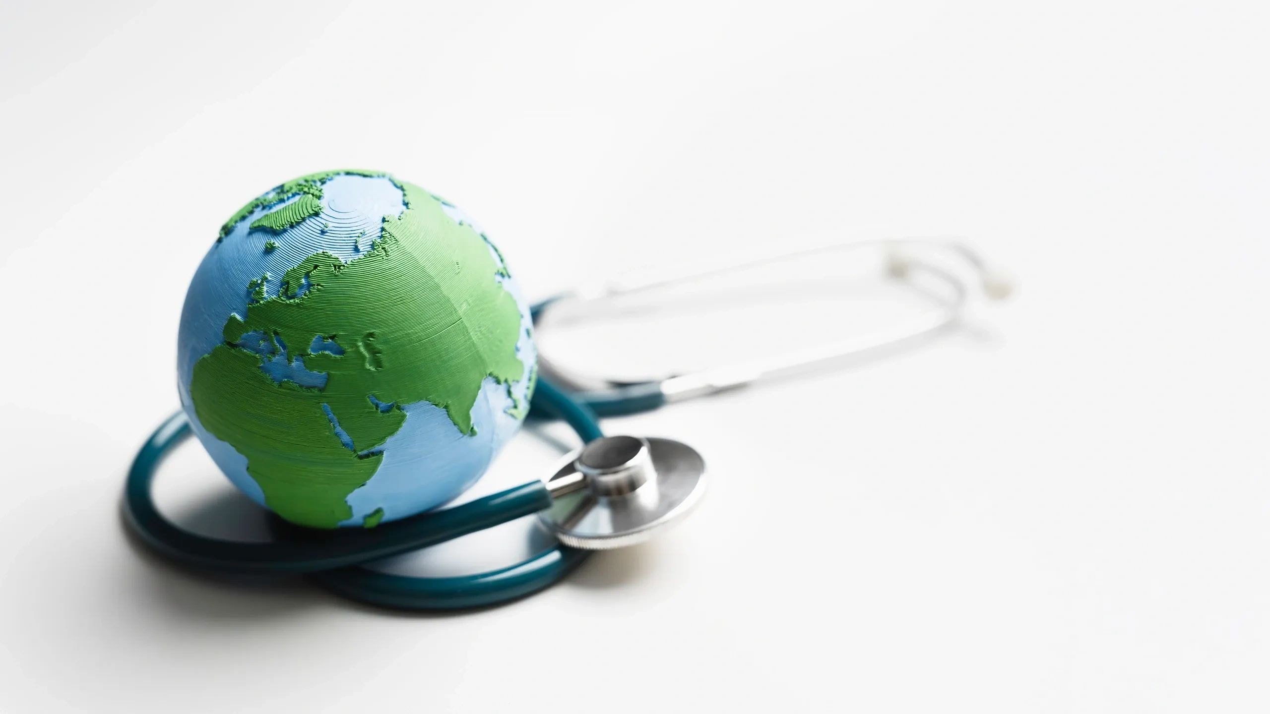 Globe with stethoscope representing global healthcare